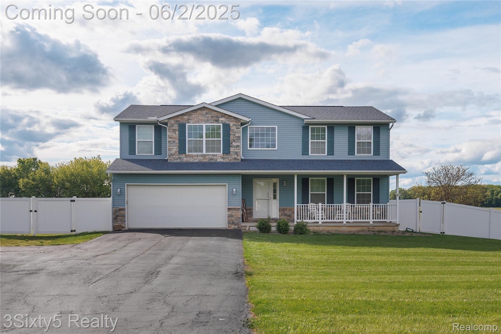 13972 Stowell Rd, Dundee, MI 48131 - view of front facade with a gate, stone siding, a porch, driveway, and a garage