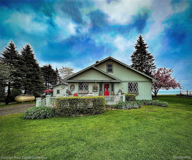 2109 S Lakeshore Rd, Harbor Beach, MI 48441 - view of front facade featuring a porch and a front yard