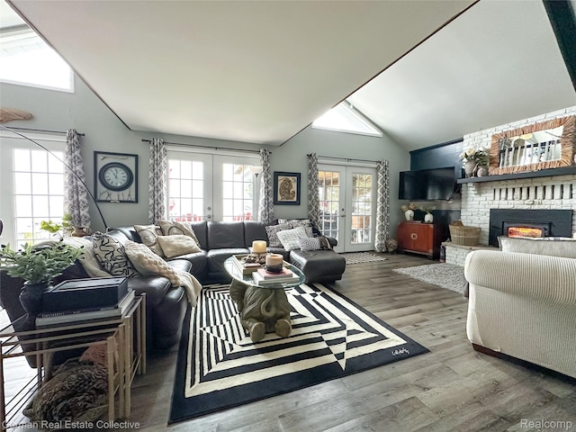 2109 S Lakeshore Rd, Harbor Beach, MI 48441 - living room featuring french doors, plenty of natural light, wood finished floors, a fireplace, and high vaulted ceiling