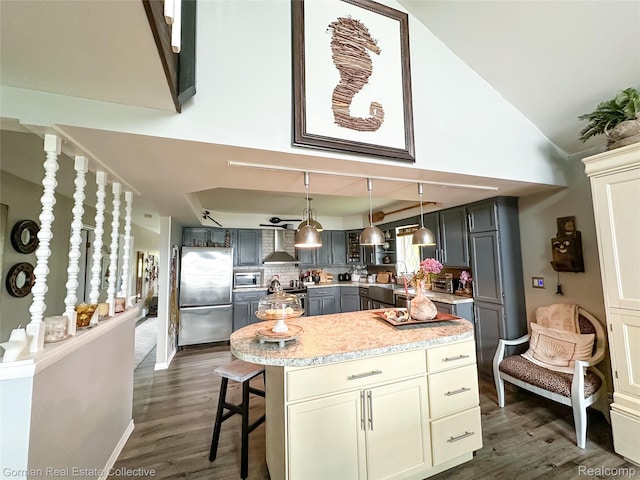 2109 S Lakeshore Rd, Harbor Beach, MI 48441 - kitchen featuring stainless steel appliances, dark wood-style flooring, gray cabinets, decorative backsplash, and lofted ceiling