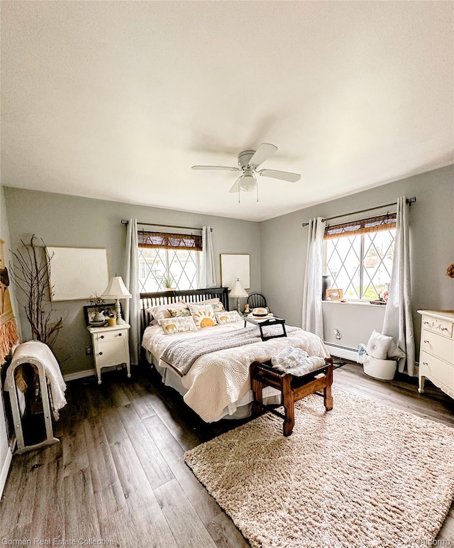 2109 S Lakeshore Rd, Harbor Beach, MI 48441 - bedroom with multiple windows, wood finished floors, and baseboard heating