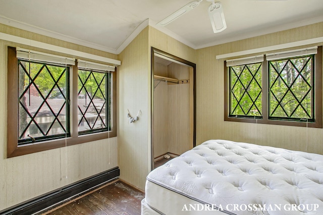 5011 Rosabelle Beach Ave, Holland, MI 49424 - bedroom featuring crown molding, dark wood finished floors, a closet, baseboards, and wallpapered walls