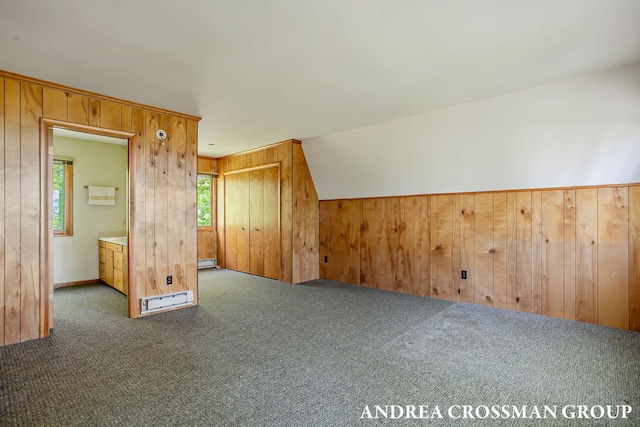 5011 Rosabelle Beach Ave, Holland, MI 49424 - additional living space featuring carpet floors, wooden walls, baseboard heating, and vaulted ceiling