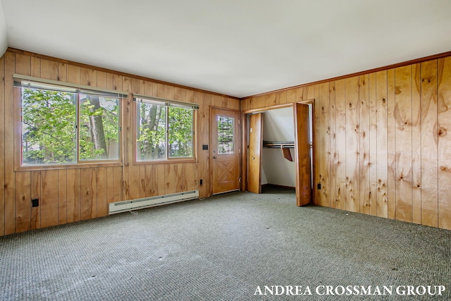 5011 Rosabelle Beach Ave, Holland, MI 49424 - spare room featuring baseboard heating, carpet floors, and wood walls