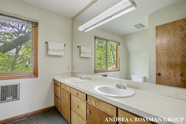 5011 Rosabelle Beach Ave, Holland, MI 49424 - bathroom with double vanity, toilet, and baseboards