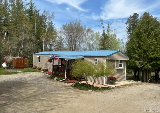 2999 Copeland Rd, Port Austin, MI 48467 - manufactured / mobile home with metal roof and a deck