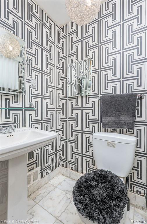 29249 Everett St, Southfield, MI 48076 - half bathroom featuring toilet and marble finish floors