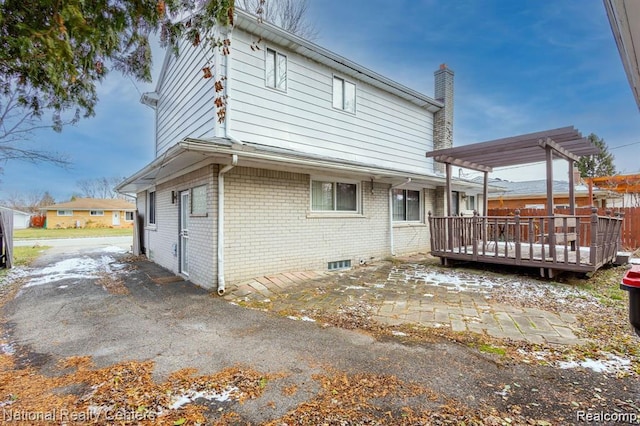 29249 Everett St, Southfield, MI 48076 - rear view of house with a pergola, a chimney, brick siding, a wooden deck, and a patio