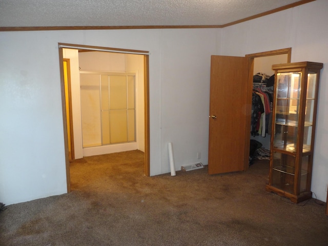 5925 113th Ave, Pullman, MI 49450 - unfurnished bedroom featuring ornamental molding, a walk in closet, carpet flooring, a closet, and a textured ceiling