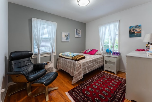 3300 Ellenboro Dr, Troy, MI 48083 - bedroom featuring wood finished floors, multiple windows, and baseboards