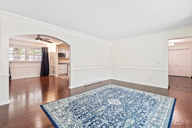 1706 Southgate Ct, Adrian, MI 49221 - unfurnished room with arched walkways, dark wood-type flooring, a ceiling fan, ornamental molding, and baseboards
