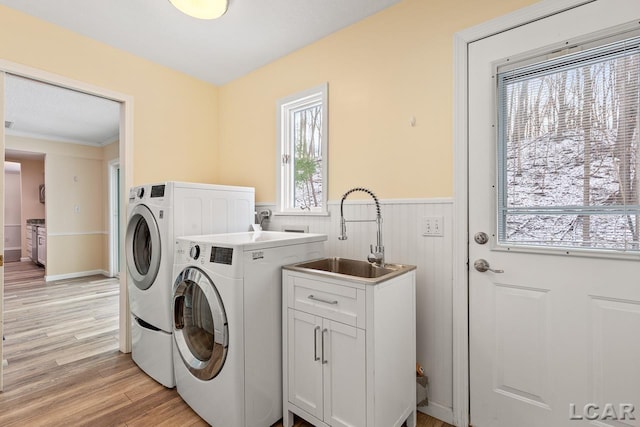 1706 Southgate Ct, Adrian, MI 49221 - washroom with washer and dryer, cabinet space, wainscoting, light wood-type flooring, and ornamental molding