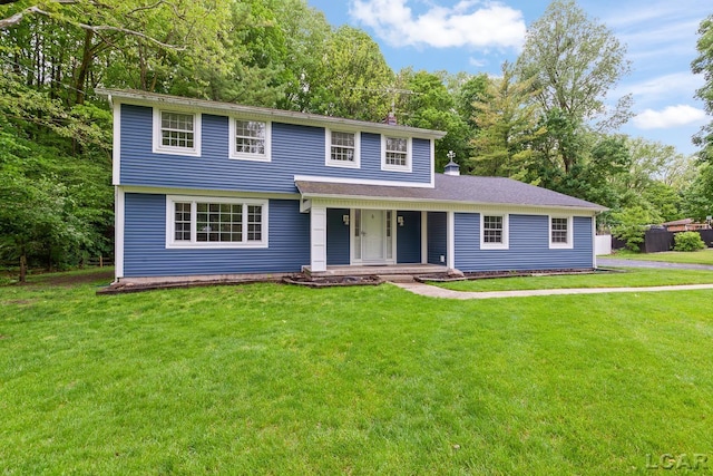 1706 Southgate Ct, Adrian, MI 49221 - view of front facade featuring covered porch, a front yard, and view of wooded area