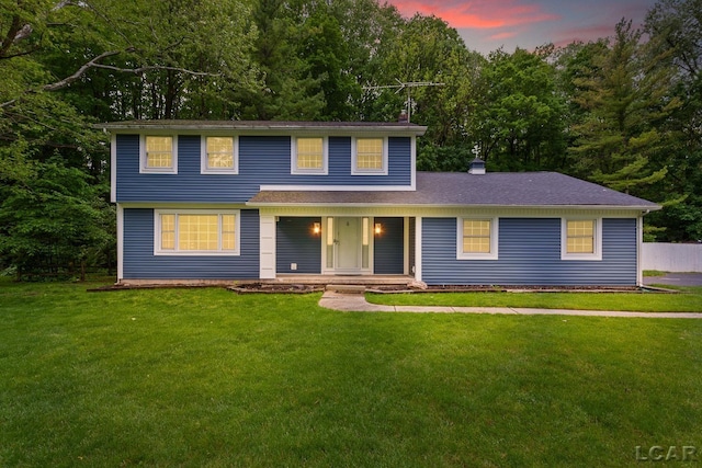 1706 Southgate Ct, Adrian, MI 49221 - view of front of home with covered porch, a chimney, and a front lawn