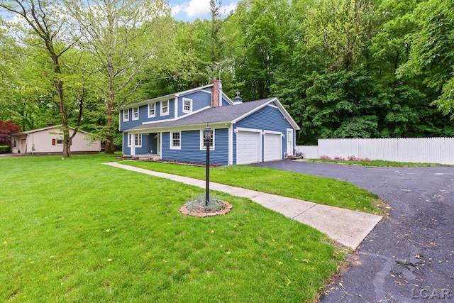1706 Southgate Ct, Adrian, MI 49221 - view of front of home featuring a garage, a chimney, and driveway