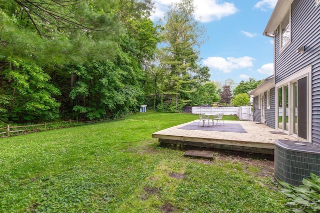 1706 Southgate Ct, Adrian, MI 49221 - view of yard featuring central AC unit, a wooden deck, and view of wooded area