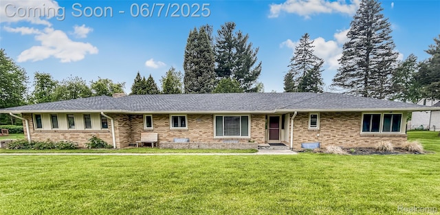 2211 N Sycamore Dr, Burton, MI 48509 - single story home with a front yard, brick siding, and a chimney