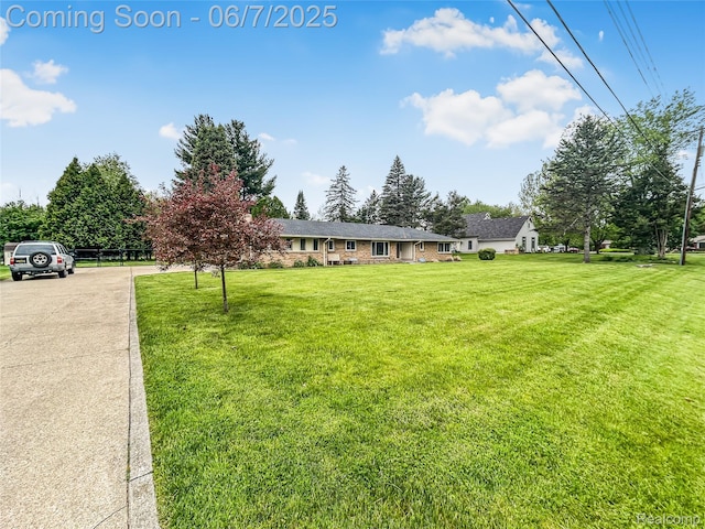2211 N Sycamore Dr, Burton, MI 48509 - view of front facade featuring a front lawn