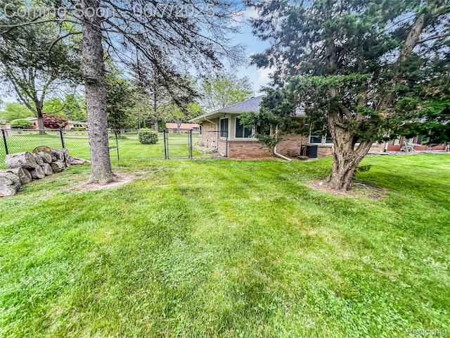 2211 N Sycamore Dr, Burton, MI 48509 - view of yard featuring a gate