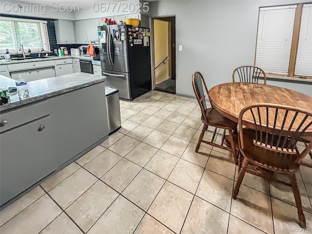 2211 N Sycamore Dr, Burton, MI 48509 - kitchen with stainless steel refrigerator with ice dispenser, a sink, light tile patterned floors, dishwasher, and gray cabinetry