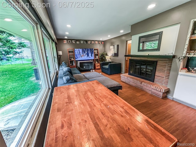 2211 N Sycamore Dr, Burton, MI 48509 - living area featuring a fireplace, wood finished floors, and recessed lighting