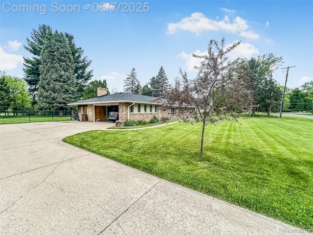 2211 N Sycamore Dr, Burton, MI 48509 - view of front facade with driveway, a garage, stone siding, and a chimney