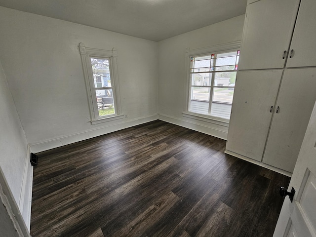 228 Meachem Ave, Battle Creek, MI 49015 - unfurnished bedroom featuring dark wood-style floors and baseboards