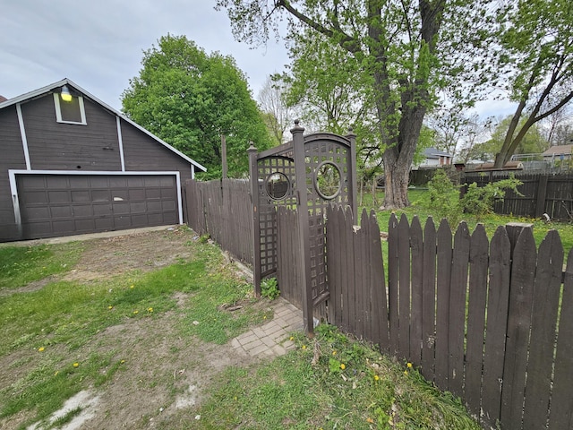 228 Meachem Ave, Battle Creek, MI 49015 - view of yard featuring a detached garage, an outdoor structure, and a gate