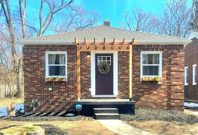 16230 Santa Rosa Dr, Detroit, MI 48221 - view of front of property featuring brick siding, a chimney, and a shingled roof