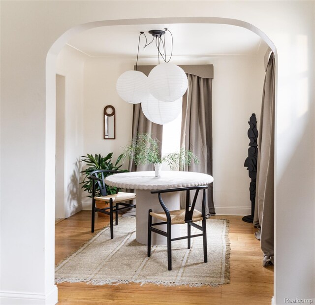 16230 Santa Rosa Dr, Detroit, MI 48221 - dining area with arched walkways, light wood-type flooring, and baseboards