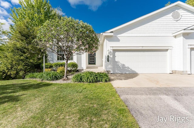 2632 E Turning Leaf Way Unit 111, Fruitport, MI 49415 - view of front of property featuring a garage, concrete driveway, and a front yard