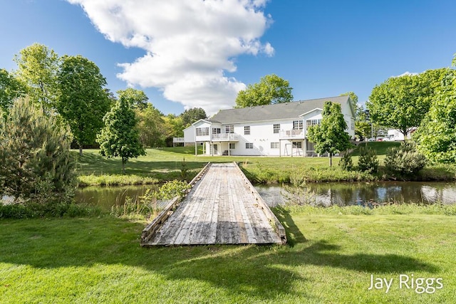 2632 E Turning Leaf Way Unit 111, Fruitport, MI 49415 - rear view of house with a water view and a lawn