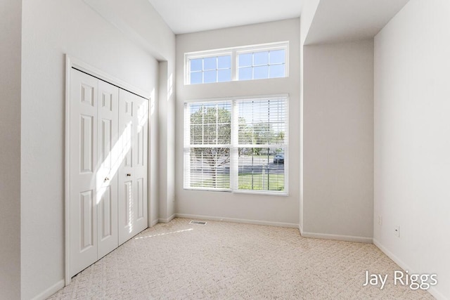 2632 E Turning Leaf Way Unit 111, Fruitport, MI 49415 - unfurnished bedroom with carpet, baseboards, and a closet