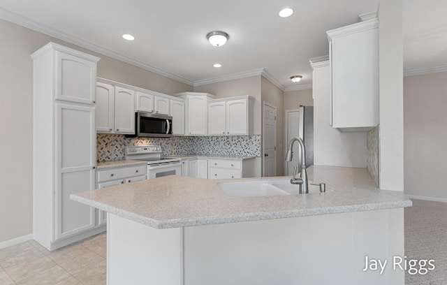 2632 E Turning Leaf Way Unit 111, Fruitport, MI 49415 - kitchen featuring white range with electric cooktop, stainless steel microwave, a sink, a peninsula, and white cabinets