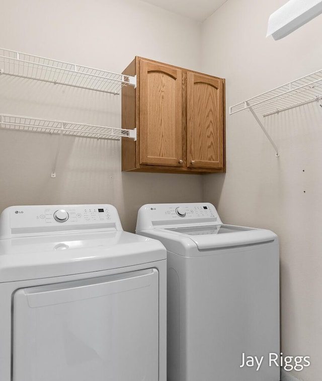 2632 E Turning Leaf Way Unit 111, Fruitport, MI 49415 - laundry room featuring cabinet space and independent washer and dryer