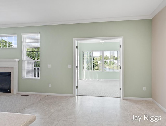 2632 E Turning Leaf Way Unit 111, Fruitport, MI 49415 - unfurnished living room with ornamental molding, baseboards, a premium fireplace, and light colored carpet