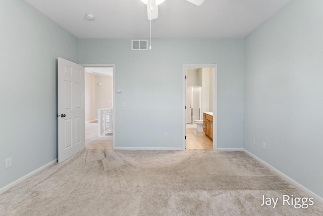 2632 E Turning Leaf Way Unit 111, Fruitport, MI 49415 - unfurnished bedroom with light carpet, baseboards, ensuite bath, and ceiling fan