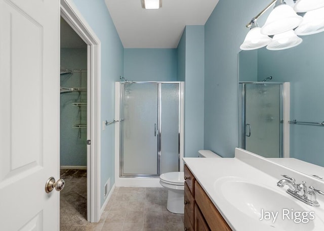 2632 E Turning Leaf Way Unit 111, Fruitport, MI 49415 - bathroom featuring a stall shower, vanity, toilet, and tile patterned flooring
