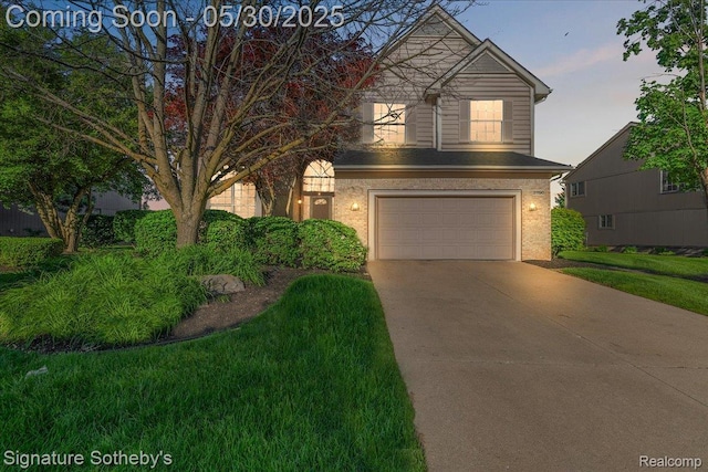 31190 Kingsley Ct, Novi, MI 48377 - view of front of property with a garage, driveway, brick siding, and a front yard