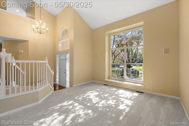 31190 Kingsley Ct, Novi, MI 48377 - entrance foyer with carpet, healthy amount of natural light, a chandelier, and high vaulted ceiling