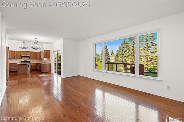 31190 Kingsley Ct, Novi, MI 48377 - unfurnished living room with a chandelier and dark wood finished floors