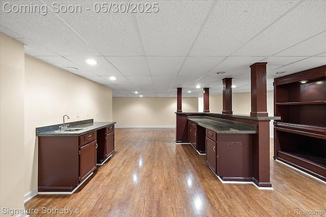 31190 Kingsley Ct, Novi, MI 48377 - kitchen featuring light wood-type flooring, dark brown cabinets, and a drop ceiling
