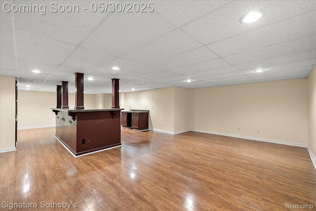 31190 Kingsley Ct, Novi, MI 48377 - finished basement with wet bar, light wood-type flooring, and a paneled ceiling