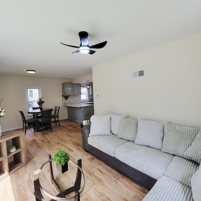 2109 Schippers Ln, Kalamazoo, MI 49048 - living area featuring light wood-style floors, ceiling fan, and baseboards