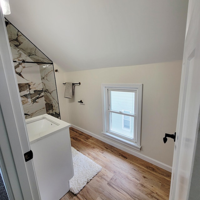 2109 Schippers Ln, Kalamazoo, MI 49048 - full bath with a marble finish shower, wood finished floors, vanity, baseboards, and lofted ceiling