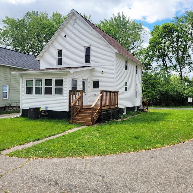 2109 Schippers Ln, Kalamazoo, MI 49048 - rear view of house featuring a lawn, a deck, and roof with shingles