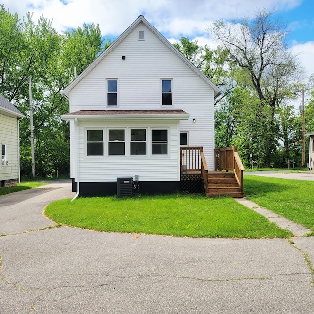 2109 Schippers Ln, Kalamazoo, MI 49048 - view of front of house with central air condition unit, a front lawn, and a wooden deck