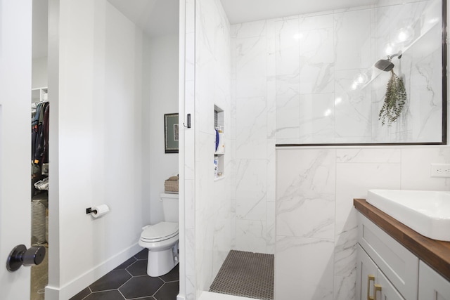 1819 Gloryfield Dr SW, Byron Center, MI 49315 - bathroom with a marble finish shower, vanity, toilet, a spacious closet, and tile patterned floors