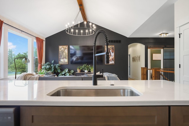 1819 Gloryfield Dr SW, Byron Center, MI 49315 - kitchen with a sink, open floor plan, a chandelier, arched walkways, and light countertops