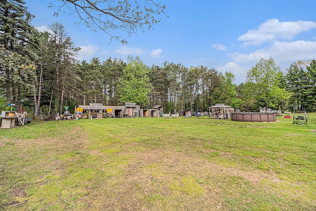 19030 W Almy Rd, Howard City, MI 49329 - view of grassy yard with an outdoor pool